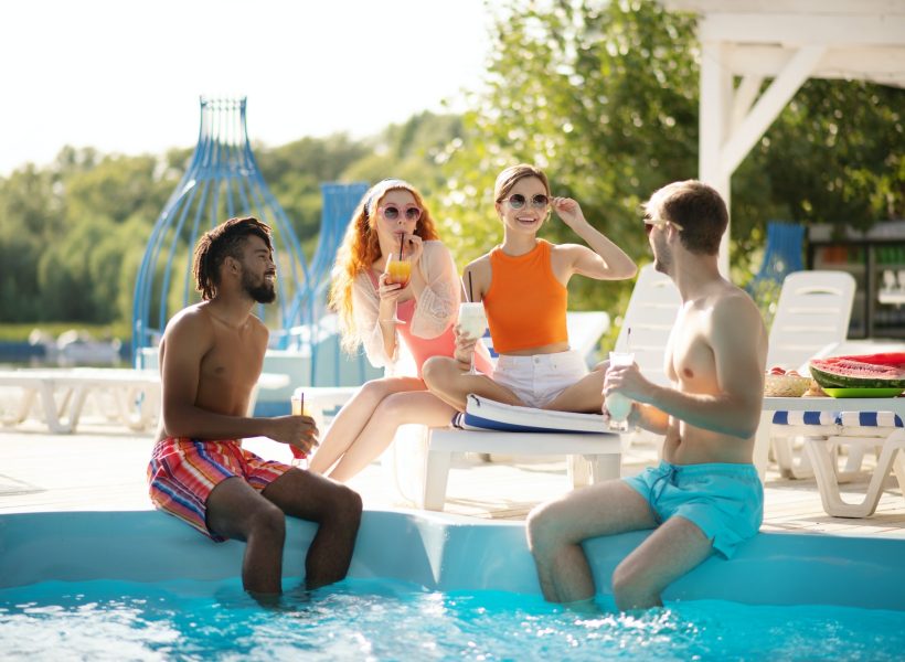 happy-girlfriends-looking-at-their-men-while-having-pool-party.jpg